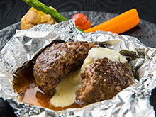 Melted thick cheese sauce hamburger steak: Popular menu item to be enjoyed with hot cheese sauce.
